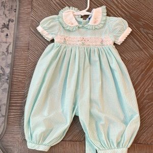 Bubble romper, smocked, snap up for easy diaper change.